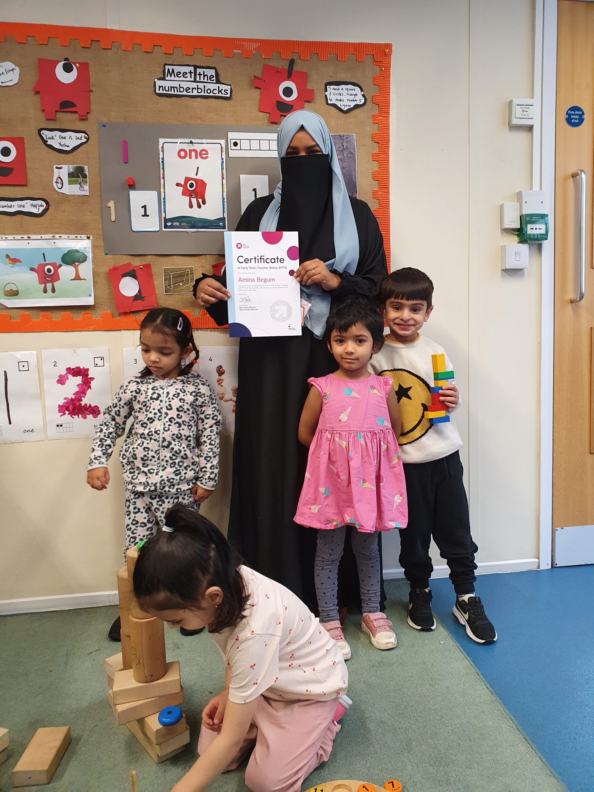 Pre-school teacher and children